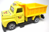 Yellow and orange diecast dump maintenance truck, side view with open cab and tipping bed