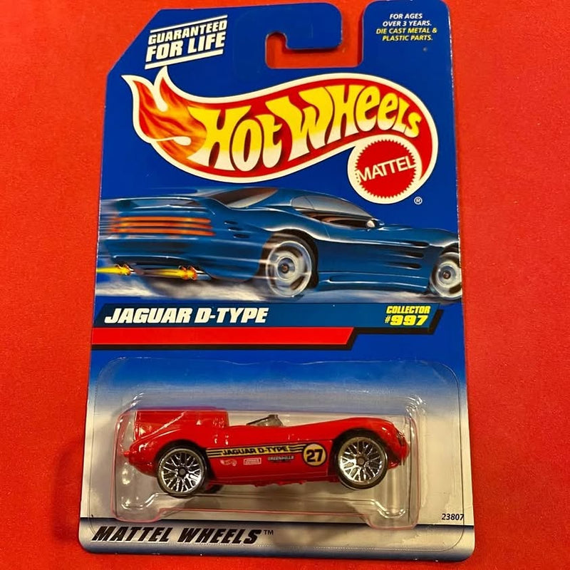 Red Jaguar D-Type diecast sports car with blister packaging, Hot Wheels label