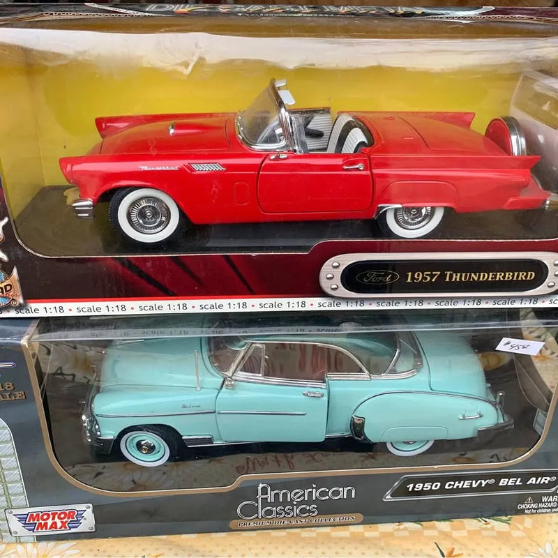 Red 1957 Thunderbird and light blue 1950 Chevy Bel Air diecast cars in boxes