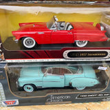 Red 1957 Thunderbird and light blue 1950 Chevy Bel Air diecast cars in boxes