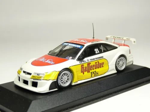 Diecast model race car in white, yellow and red with front 3/4 view, roof antenna