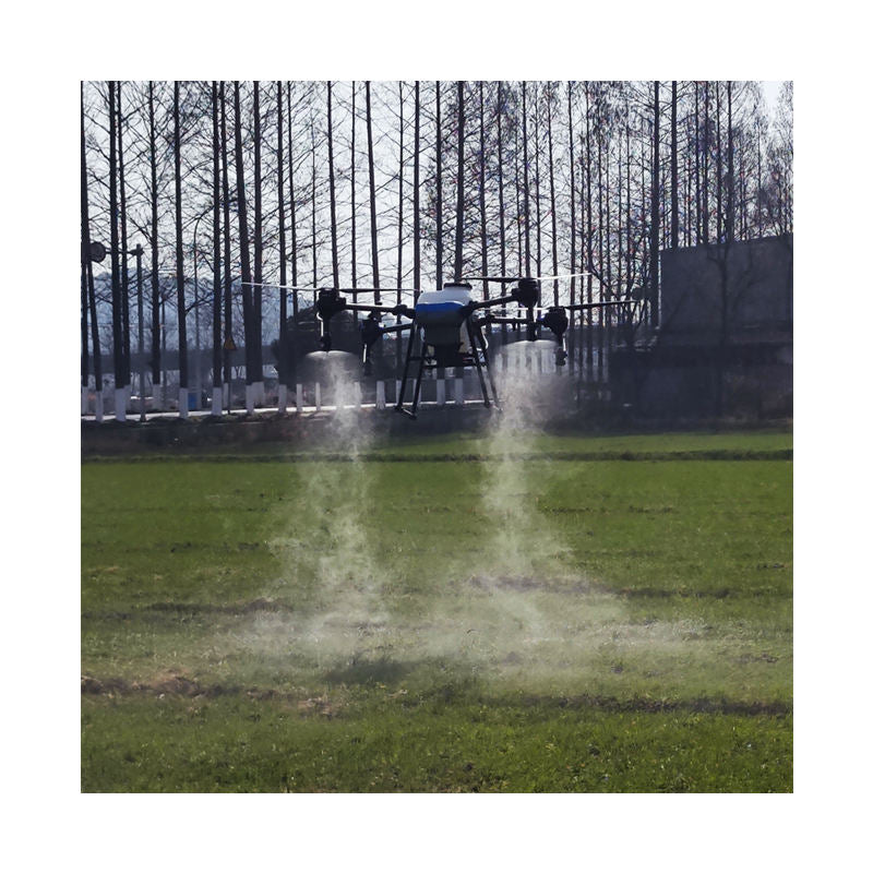 Agricultural fertilizing spray drone releasing mist over a field