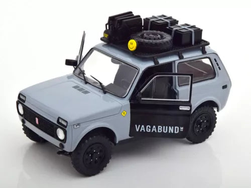 1/18 diecast SUV model car in gray with black wheels and roof spare tire, front view