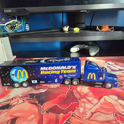 Diecast semi truck with McDonald's Racing Team graphics, blue and black, flame decals