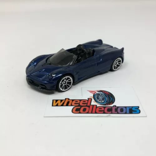 Blue roadster diecast model car, 1:64 scale, front 3/4 view on display card
