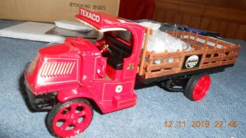 Diecast flatbed delivery truck with red cab and orange wooden-style bed