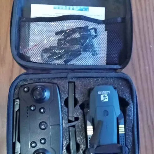 Camera drone in open case, blue and black body with propellers