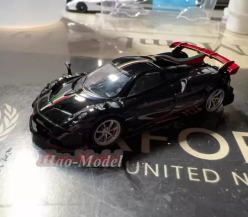 Black 1/64 diecast sports car model with red accent on top