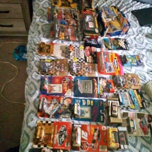 Diecast NASCAR car collection crate with many boxed cars in varied colors