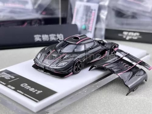 1:64 scale diecast racing car model, black carbon fiber look with pink accents