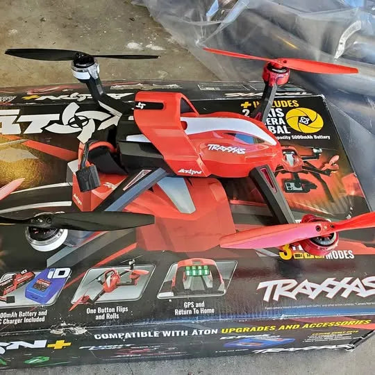 Red and black racing drone with propellers and ATON upgrade panel