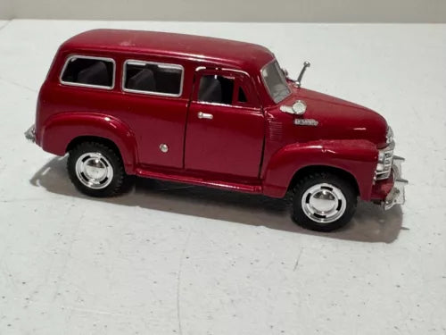 Red diecast 1950 Chevrolet Suburban toy car, 1:36 scale, side view