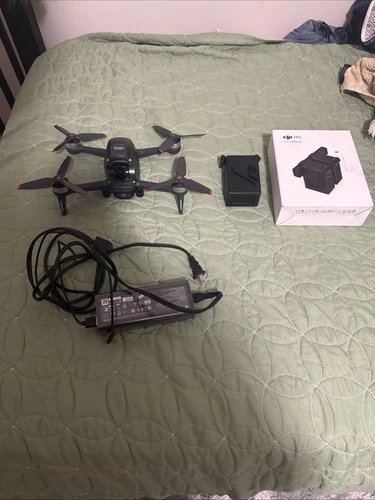 DJI FPV camera drone kit with quadcopter, goggles, cables and box