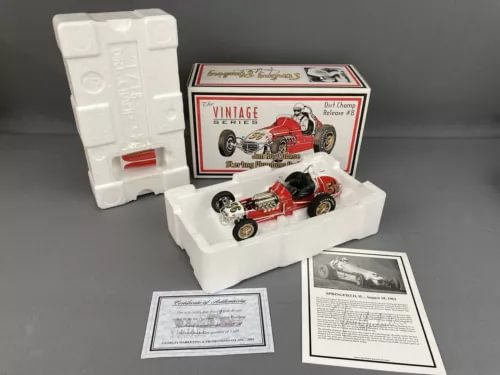 Vintage diecast race car model with box and papers, red and black