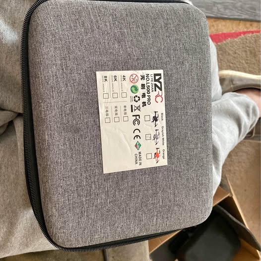 Gray zippered drone carrying case with product label on fabric