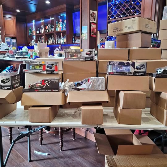Packaged 1:24 diecast race cars in labeled retail boxes