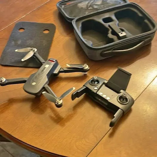 Folding drone with camera, remote controller, and padded carry case