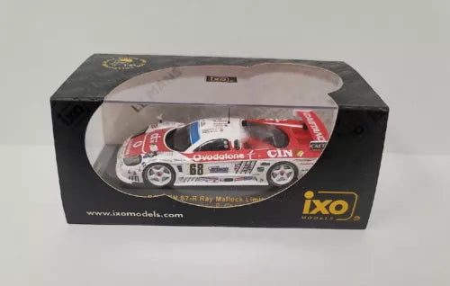 Diecast race car model in retail box, white with red and blue livery