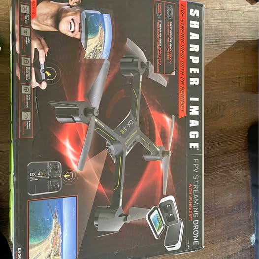 Folding quadcopter drone in retail box, with remote controller and screen