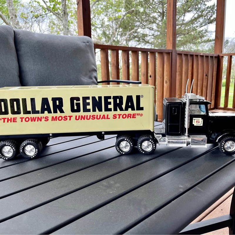 Black diecast semi truck model with Dollar General trailer and detailed chrome wheels