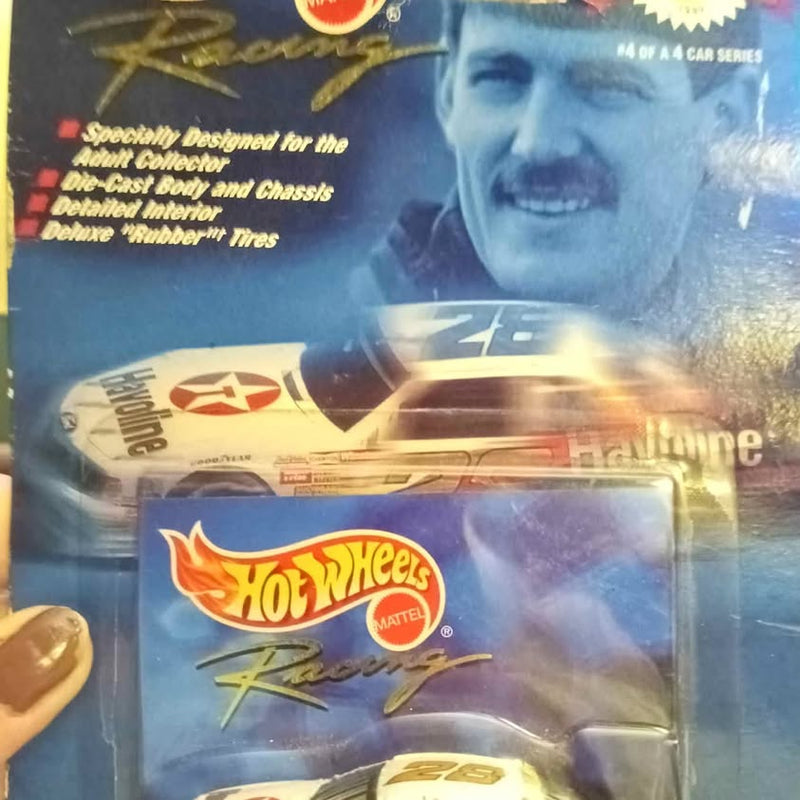 Hot Wheels diecast car in blister pack, Racing-style logo and Mattel mark