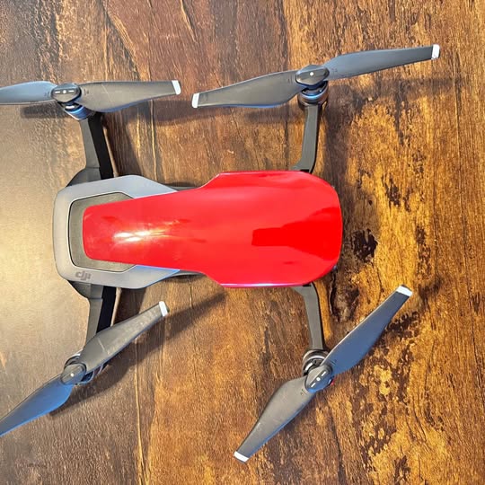 Red DJI quadcopter drone with four folding propellers