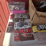 Diecast toy car set with several vehicles in an open box