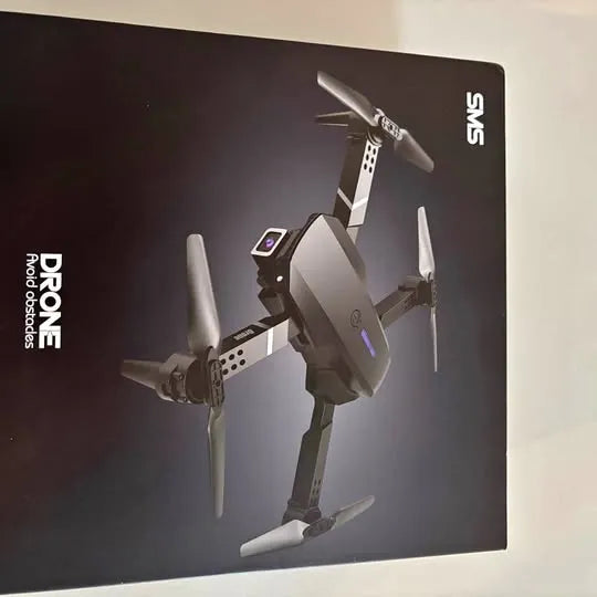 Foldable quadcopter drone with four propellers and camera module, dark gray