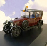 Maroon vintage die-cast model car with chrome grille, headlights, and front wheels