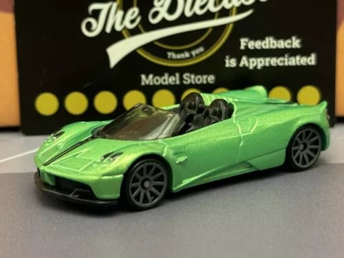 Green diecast roadster car with black wheels, front three-quarter view
