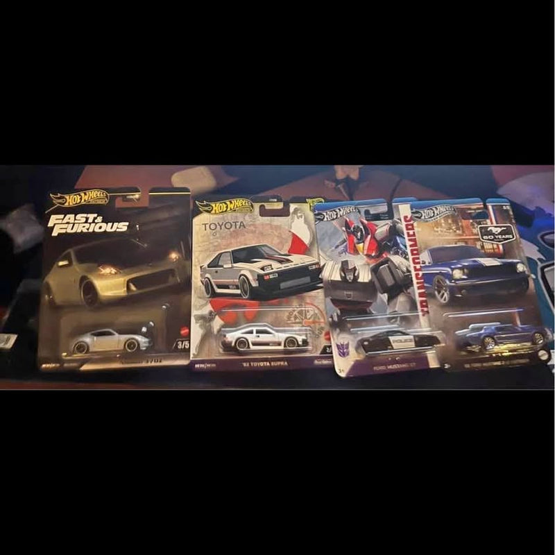 Diecast toy car blister pack with black and red racing cars on card