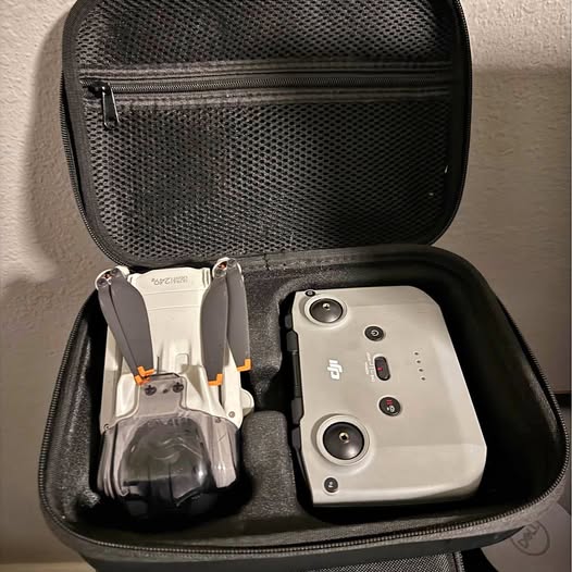 DJI Mini 3 drone hard case with zippered mesh shell, holding drone and remote