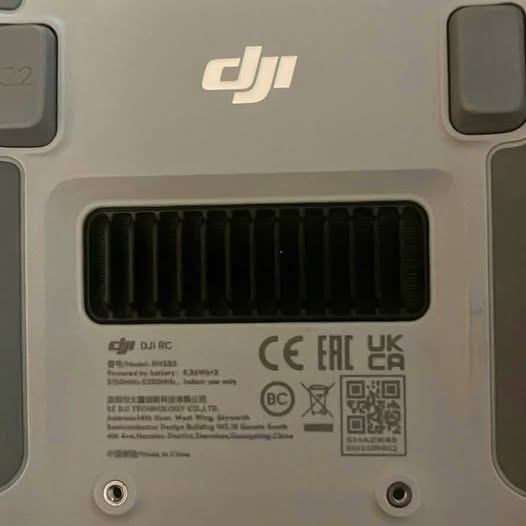 DJI remote controller rear panel with vents, ports, and regulatory labels