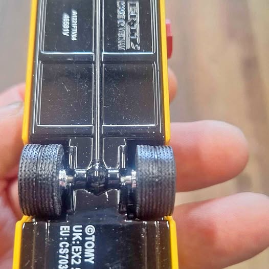 Diecast bus front wheels and undercarriage, yellow base with black details