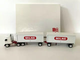 White diecast semi truck with two box trailers, red MILNE logos