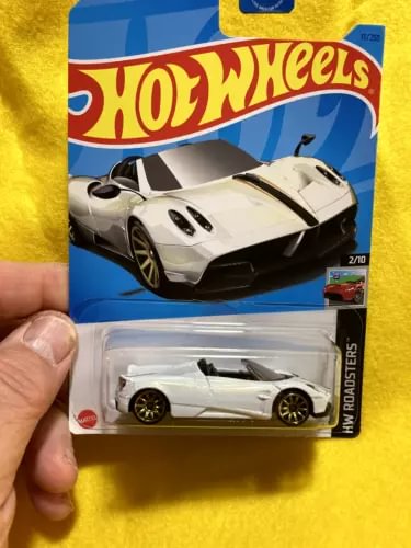 Hot Wheels diecast roadster model car, white with black wheels in blister pack