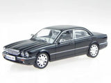 Black diecast model sedan car with chrome grille and front three-quarter view