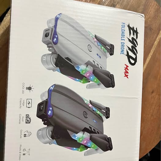 E99 dual-camera drone with blue LED lights, shown on product box
