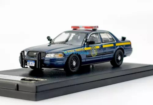 Diecast police car model, dark blue sedan with roof light bar, front view