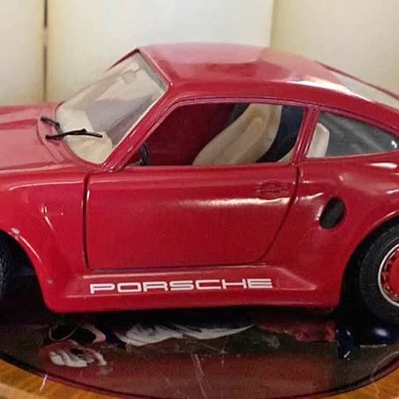 Red Porsche 959 diecast sports car, 1:24 scale, front-side view
