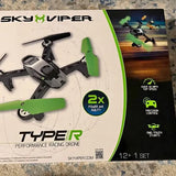 Racing drone retail box showing a black drone with green propellers and controller features