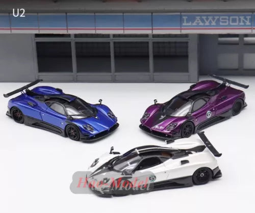 Diecast sports car models: blue, purple, and white with raised hood