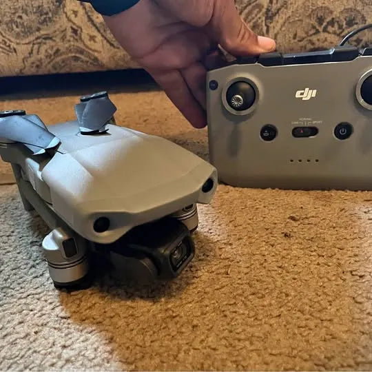 DJI Mavic Air 2 drone, camera gimbal and front body ports visible on beige unit