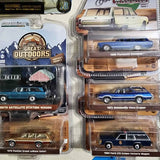 Diecast station wagon toy cars in blister packaging, multiple cars visible
