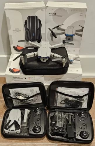 Folded drone with 2-camera system in open carrying case with accessories
