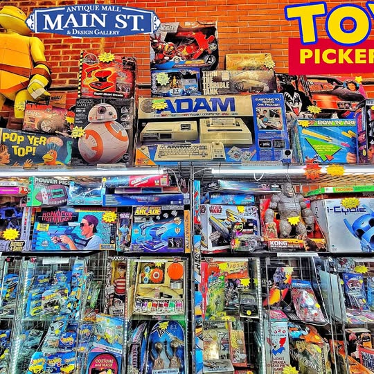 Assorted vintage trading card wax packs in display rack, colorful card designs