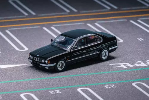 1:64 black sedan diecast metal model car, front three-quarter view