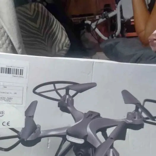Gray quadcopter drone with four propellers and visible camera mount