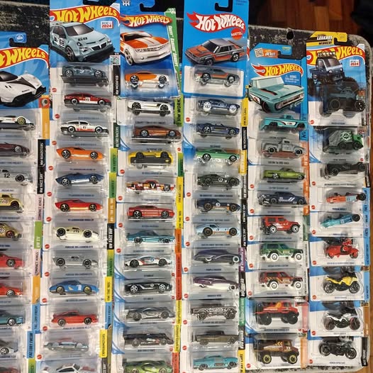 Diecast car lot with multiple blister-pack toy cars in assorted colors