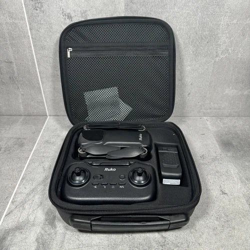 Black drone in hard-shell carrying case with remote controller